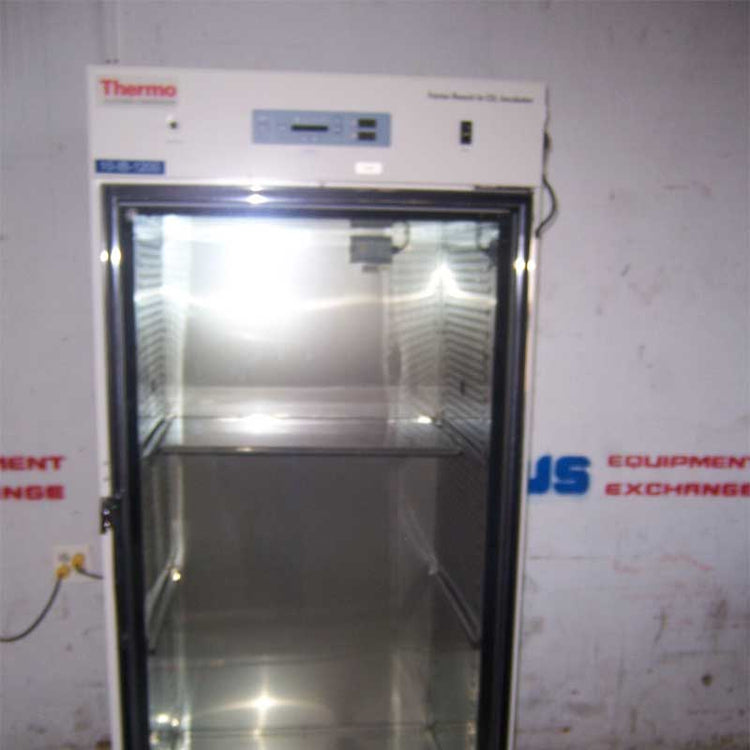 Thermo used lab oven in a room with visible us equipment exchange logo on white wall