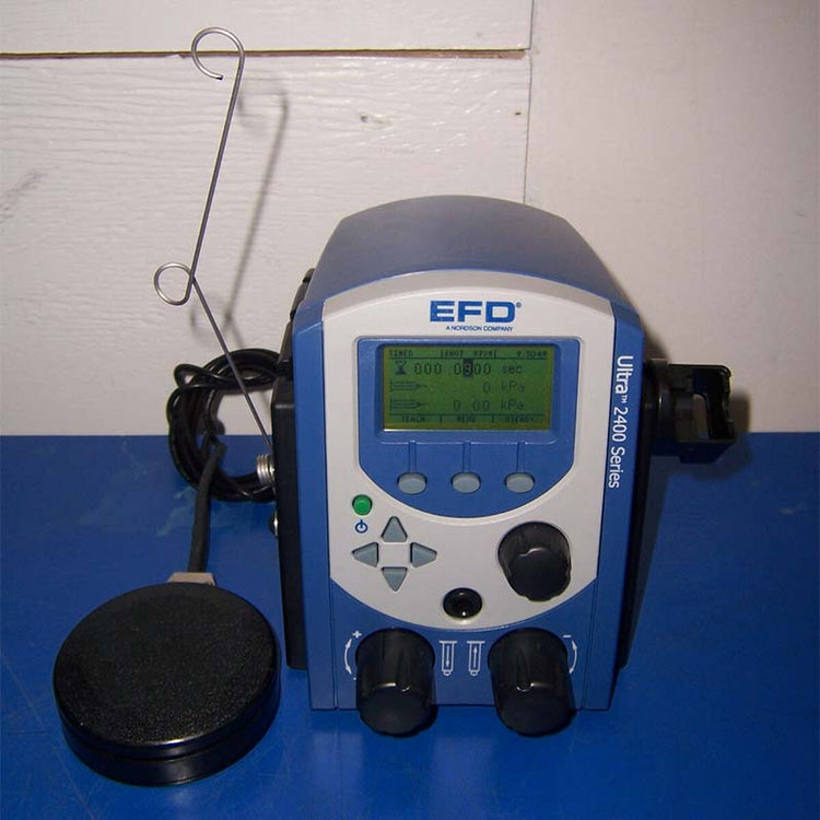 EFD Ultra 2400 Series device on a blue surface with a white wall background