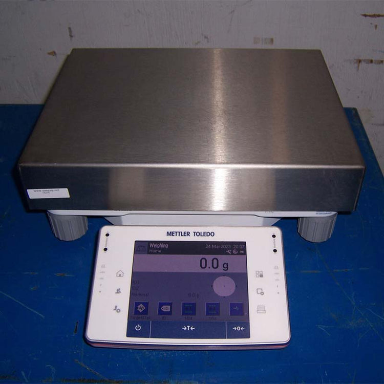Mettler Toledo scale on a blue surface with a metallic platform