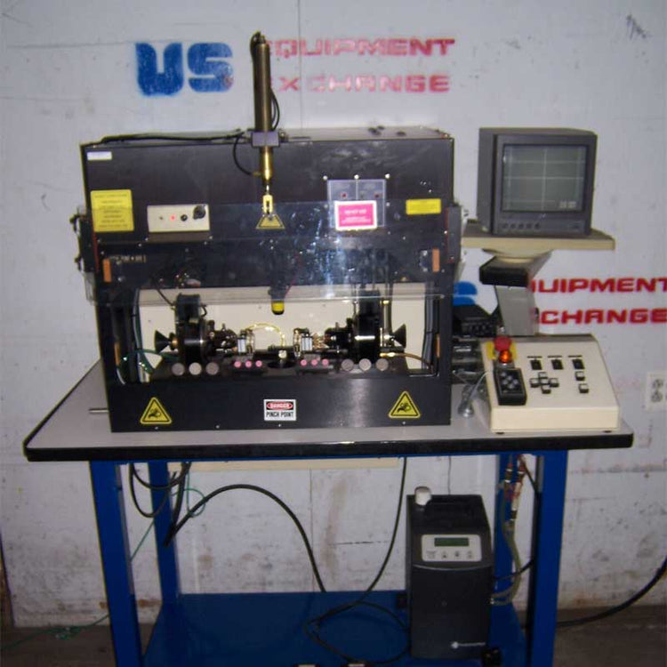 Custom laser bonder reflow on a stand with a monitor and control panel against a wall with 'US Equipment Exchange' branding.