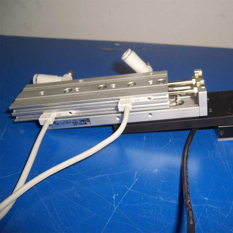 pneumatic slide with wires on a blue surface
