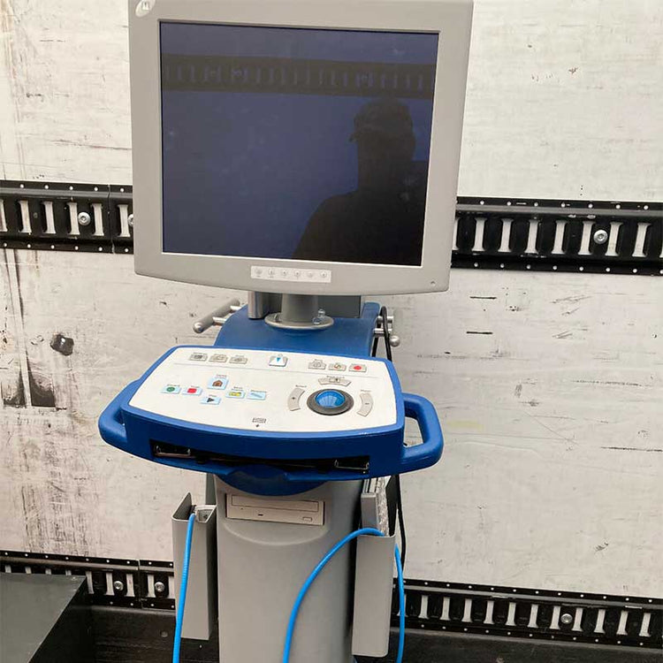 Medical device with a screen and control panel on a white brick wall background