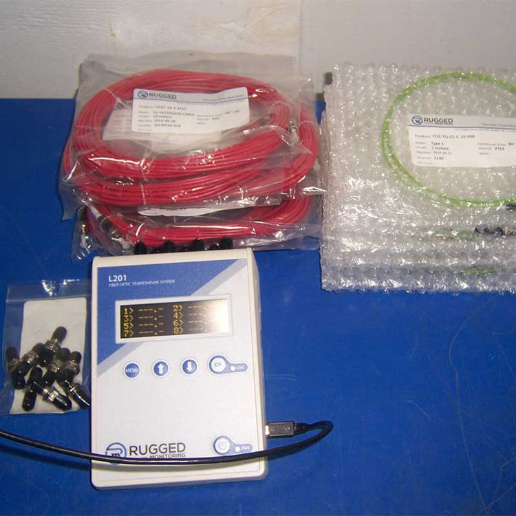 Rugged fiber optic temp system with red cable and bubble wrap on a blue surface