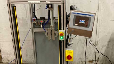 allen bradley mandrel puller with control panel and buttons on a concrete floor.