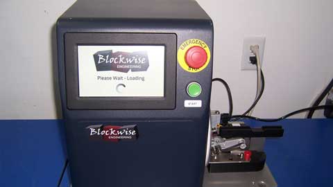 Blockwise electronic device with screen and buttons on a blue surface