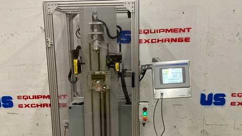 Industrial equipment with a control panel on a wall branded with 'US Equipment Exchange'.