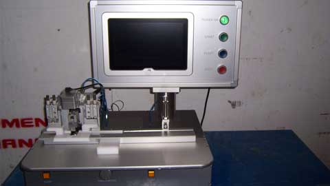 Medical device with a screen and control panel on a blue surface.