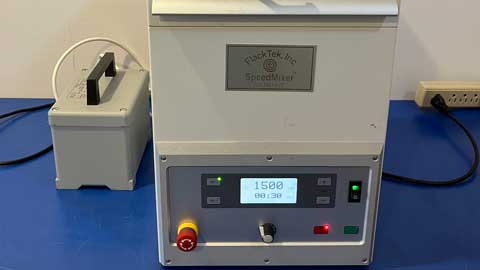 Lab equipment with digital display on a blue surface